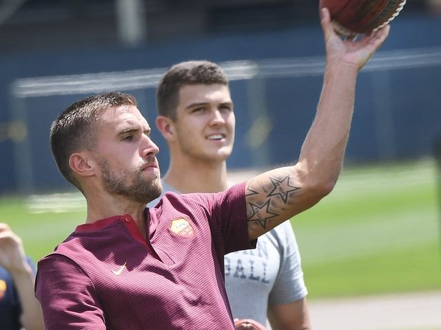 John O'Korn coaches Kevin Strootman of AS Roma on how to throw a football during a Michigan-Roma exchange.