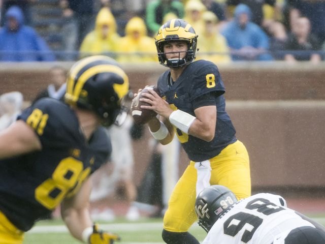 John O'Korn drops back to pass against UCF at Michigan Stadium.