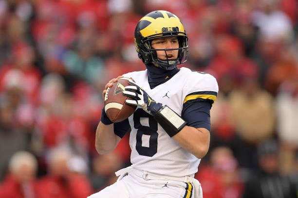 John O'Korn drops back to pass against Wisconsin.