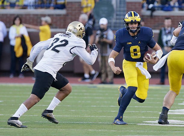 John O'Korn scrambles against Colorado at Michigan Stadium.