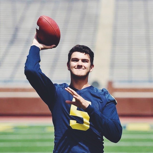 John O'Korn throws a pass during a photo shoot in Michigan Stadium.