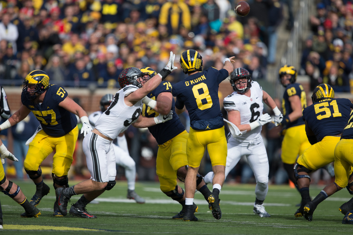The Michigan football team huddles at Michigan Stadium — the Big House